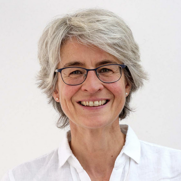 Smiling woman wearing glasses.