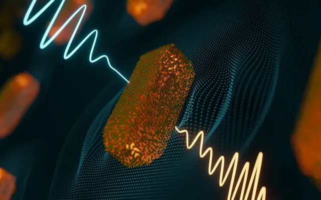 Abstrakte Darstellung von Nanostrukturen mit orangefarbenen Partikeln und zwei farbigen Wellenlinien auf dunklem Hintergrund.
