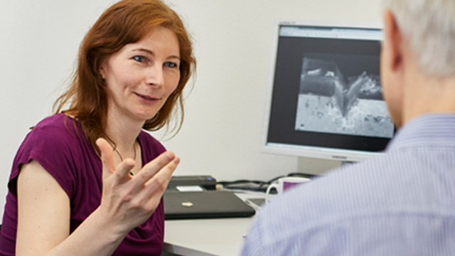 Christina Krywka talking to a colleague.