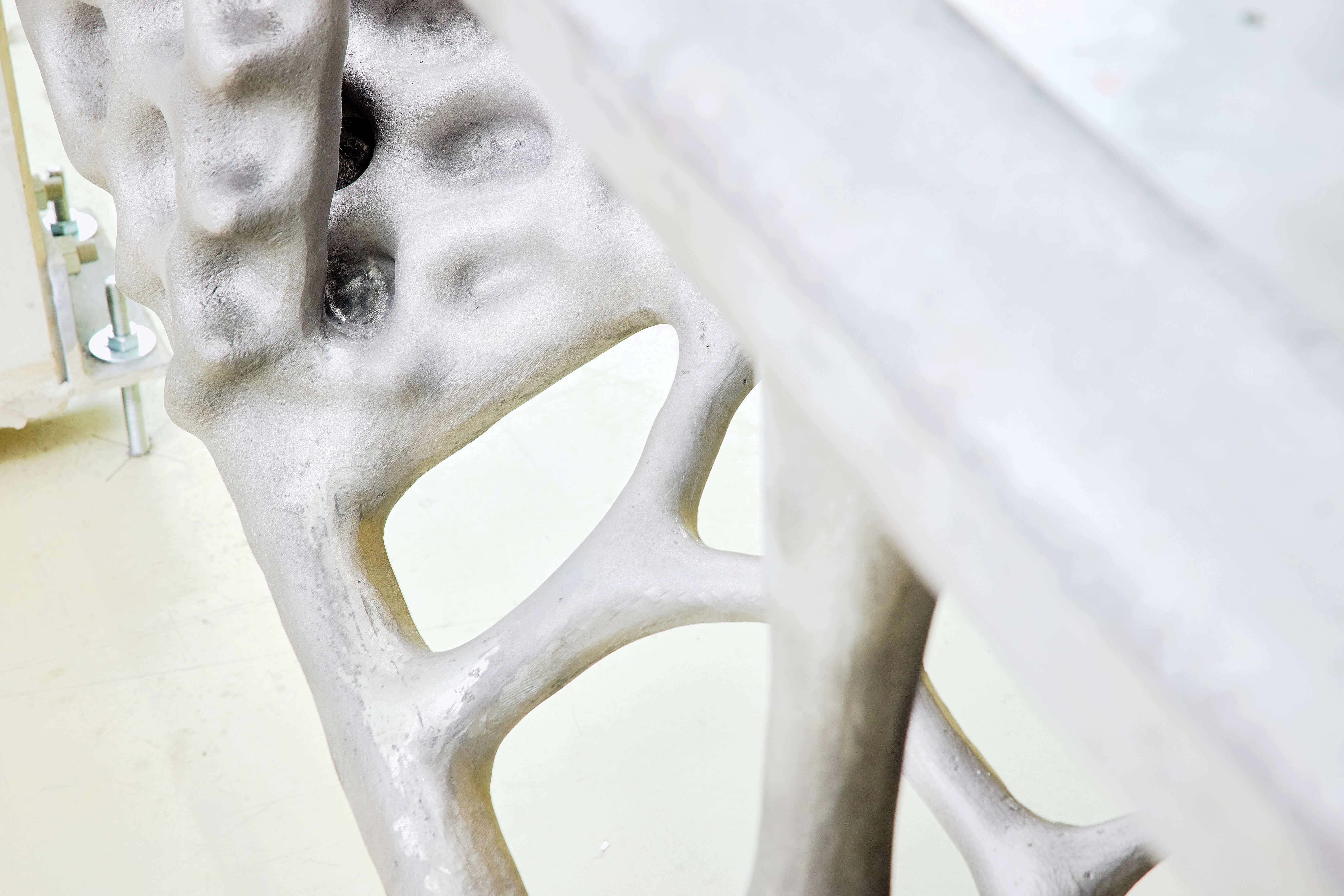 A metal frame with struts and holes